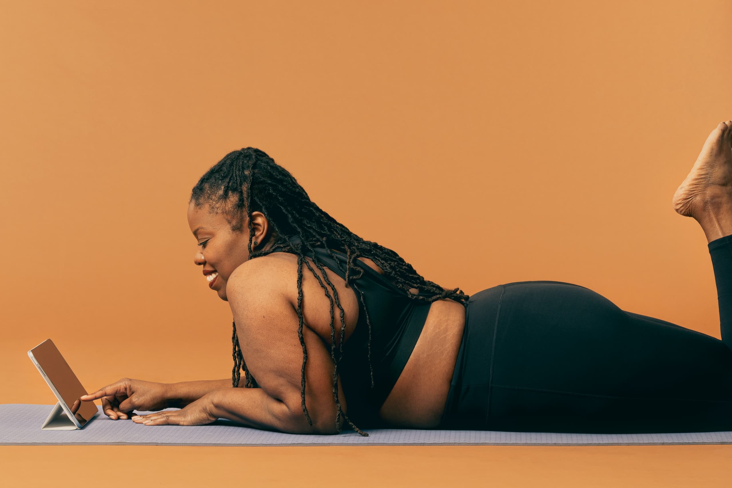 Woman smiling on yoga mat